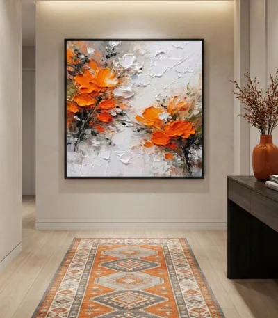 Textured abstract hand-painted canvas depicting orange and white flowers with gestural brushstrokes in warm tones, modern entryway