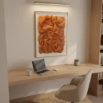 Textured abstract hand-painted canvas in warm terracotta and burnt orange tones, contemporary workspace