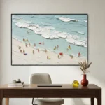 Textured contemporary hand-painted canvas depicting beachgoers and surfboards in turquoise waves and cream sand tones, modern office setting