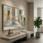 Textured impressionist painting depicting a weathered Mediterranean alleyway in cream, ochre, and blue tones, hand-painted canvas in contemporary interior