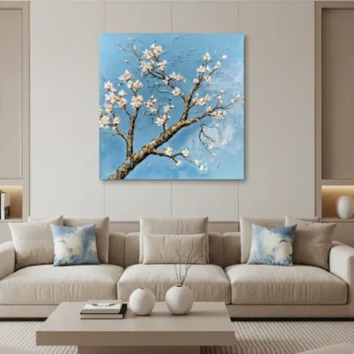 Textured contemporary hand-painted canvas of delicate white blossoms on gnarled branch against bright blue sky, modern living space