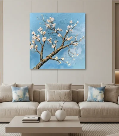 Textured contemporary hand-painted canvas of delicate white blossoms on gnarled branch against bright blue sky, modern living space