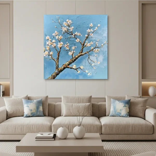 Textured contemporary hand-painted canvas of delicate white blossoms on gnarled branch against bright blue sky, modern living space