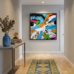Gestural abstract expressionist hand-painted canvas with vibrant rainbow brushstrokes and bold black line work, contemporary entryway
