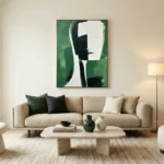 Contemporary abstract hand-painted canvas featuring geometric facial profile in green, black and cream tones, modern living space