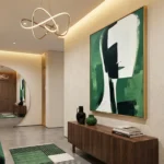 Contemporary abstract hand-painted canvas in emerald green, cream, and black gestural strokes, modern entryway