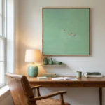 Minimalist figurative hand-painted canvas depicting swimmers in turquoise water, soft coral and seafoam palette, contemporary workspace