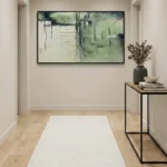 Layered abstract landscape hand-painted canvas in soft green and cream tones, contemporary entryway