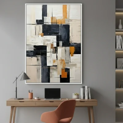 Layered abstract hand-painted canvas in black, cream, and ochre geometric blocks, modern workspace