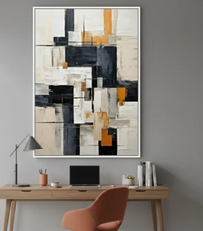 Layered abstract hand-painted canvas in black, cream, and ochre geometric blocks, modern workspace