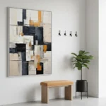 Layered abstract hand-painted canvas in black, cream, and ochre geometric blocks, contemporary entryway