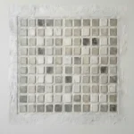 Textured minimalist wall art featuring a grid of hand-painted cream and taupe squares with subtle tonal variations, contemporary living space