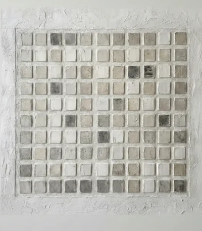 Textured minimalist wall art featuring a grid of hand-painted cream and taupe squares with subtle tonal variations, contemporary living space