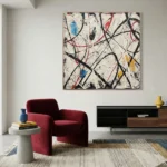 Gestural abstract expressionist hand-painted canvas with energetic black, red, and blue brushstrokes on cream, contemporary living space