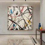 Gestural abstract expressionist hand-painted canvas with dynamic black, red, and blue strokes on cream, contemporary interior
