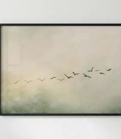 Minimalist hand-painted canvas depicting a flock of birds in formation flying through misty, muted green and cream tones, modern interior