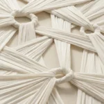 Textured abstract hand-painted canvas with layered cream and ivory fabric-like strokes and geometric knots, monochromatic palette