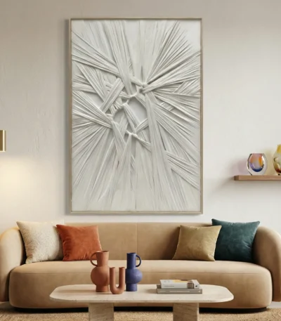Textured abstract hand-painted canvas with layered white brushstrokes and dimensional relief detail in monochrome, contemporary living space