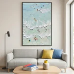 Layered abstract hand-painted canvas depicting aerial beach scene with swimmers and waves in soft aqua and cream, contemporary living space