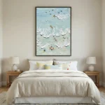Impressionist hand-painted canvas depicting beach swimmers and ocean waves in soft turquoise and cream tones, contemporary bedroom