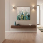 Contemporary hand-painted canvas of layered wildflowers in soft greens, whites, and golden tones, modern entryway