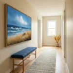 Impressionist seascape hand-painted canvas featuring windswept golden grasses, rolling ocean waves, and dramatic blue sky, hallway setting
