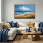 Contemporary landscape hand-painted canvas depicting golden coastal grasses, turbulent ocean waves, and dramatic sky in blue and ochre tones, modern living space