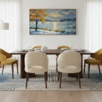 Impressionist landscape hand-painted canvas depicting a golden tree by a snowy winter lake, cool blue and warm ochre palette, dining space setting