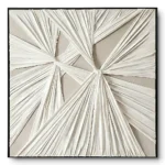 Ivory pleated fabric wall relief with several radiating star-burst folds on a taupe ground, black frame