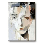 Textured abstract painting of a face in white, grey and tan impasto with gold leaf flecks, thin gold frame