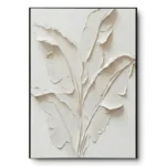 All-white plaster relief of banana leaf fronds, black thin frame