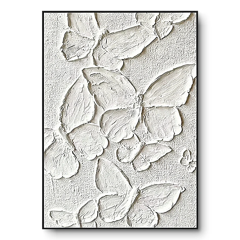 All-white plaster relief of layered overlapping butterfly-wing shapes, black thin frame