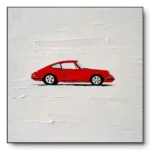Hand-painted minimalist artwork of a small red vintage car on a textured off-white plaster background, thin dark frame