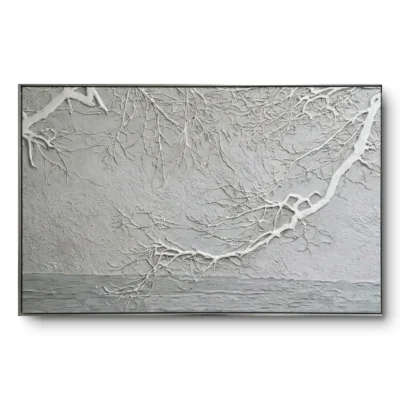 Textured relief painting of raised white frosted branches against a grey wall and water horizon, black thin frame