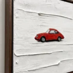 Red Coupe textured wall art shown framed on the wall in a styled interior