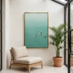 Two Swimmers textured wall art shown framed on the wall in a styled interior