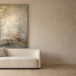 Whispering Opulence textured wabi-sabi canvas hung above a cream sofa against a limewash wall