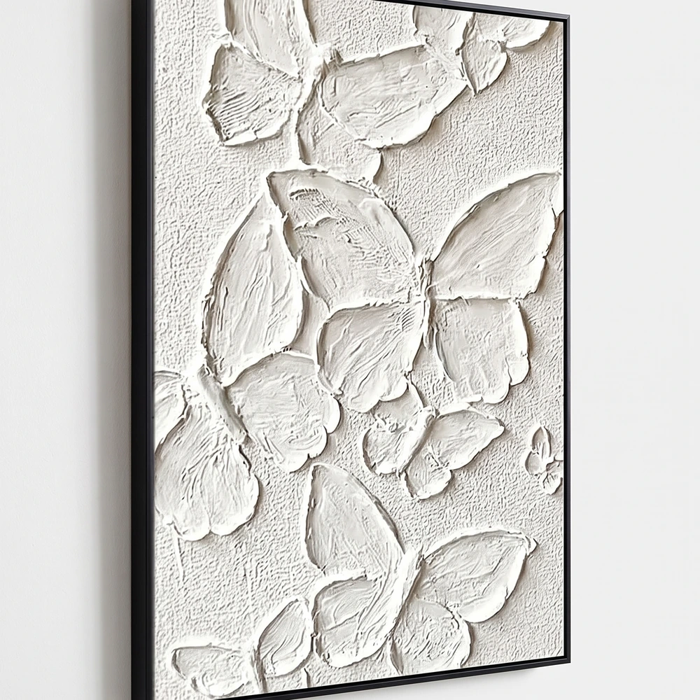 Plaster Wings textured wall art shown framed on the wall in a styled interior