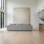 Large landscape canvas above a sofa in an open-plan Australian living room with high ceilings and pale oak floors