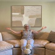 Textured abstract hand-painted canvas in cream and taupe tones with organic gestural forms, contemporary living space