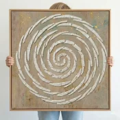 Textured hand-painted canvas with concentric white spiral pattern on muted earth tones and gold leaf accents
