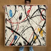 Abstract expressionist hand-painted canvas with dynamic black and red gestural strokes, blue and yellow accents, cream background