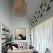 Gestural abstract painting in cream and charcoal with dynamic brushwork, contemporary living space